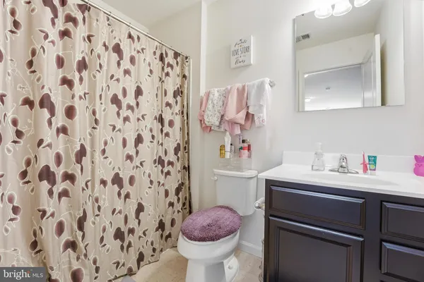 a bathroom with a sink toilet and a mirror