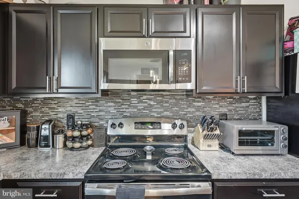 a kitchen with granite countertop stainless steel appliances and cabinets