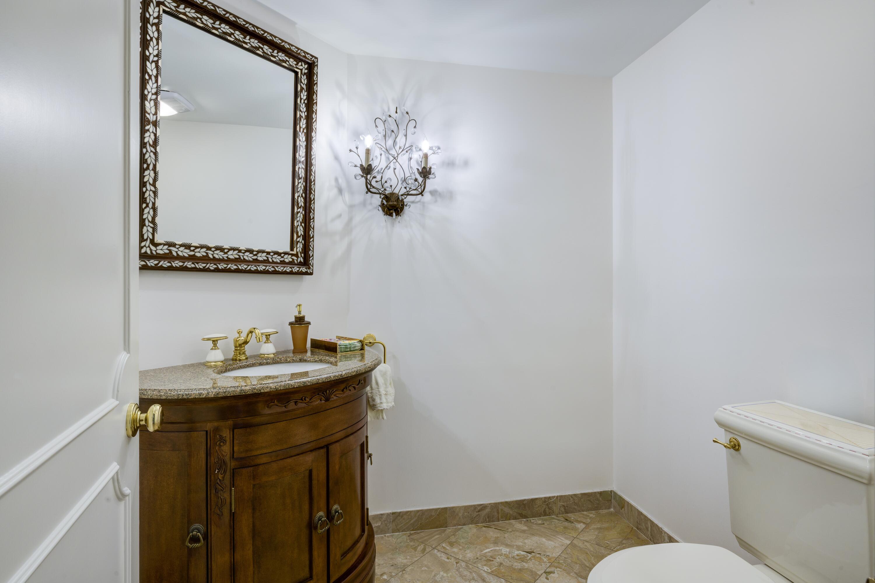 3120 South Ocean Boulevard, Unit 3602 Palm Beach, FL 33480 - Photo 13 of 22 a bathroom with a sink a toilet and mirror