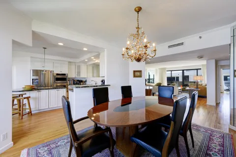 a kitchen with kitchen island granite countertop a sink a counter top space appliances and cabinets