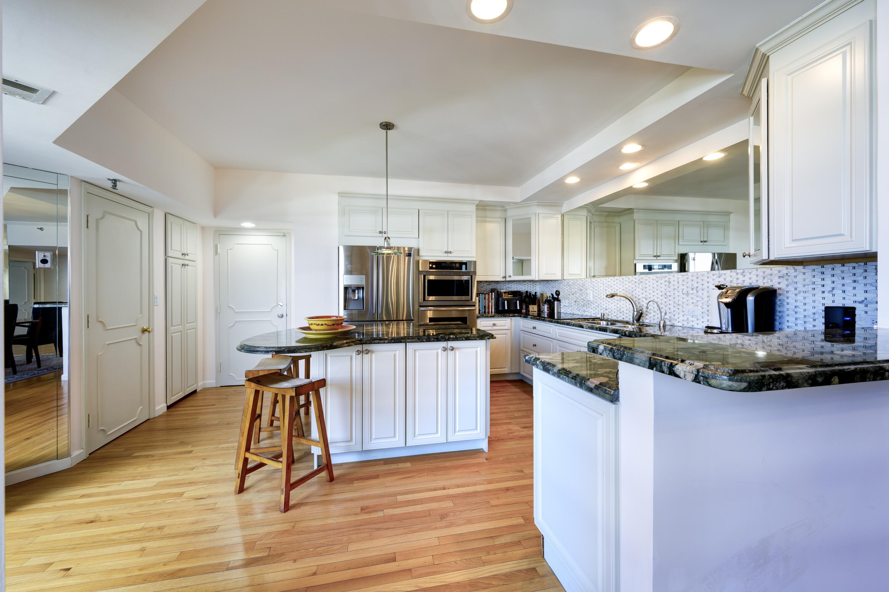 3120 South Ocean Boulevard, Unit 3602 Palm Beach, FL 33480 - Photo 15 of 22 a kitchen with kitchen island granite countertop a sink a counter top space appliances and cabinets