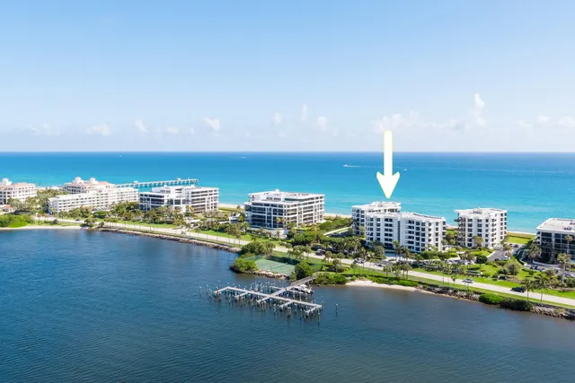 a view of a lake with a table and chairs
