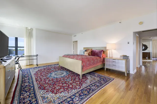 a bathroom with a large tub a shower and view