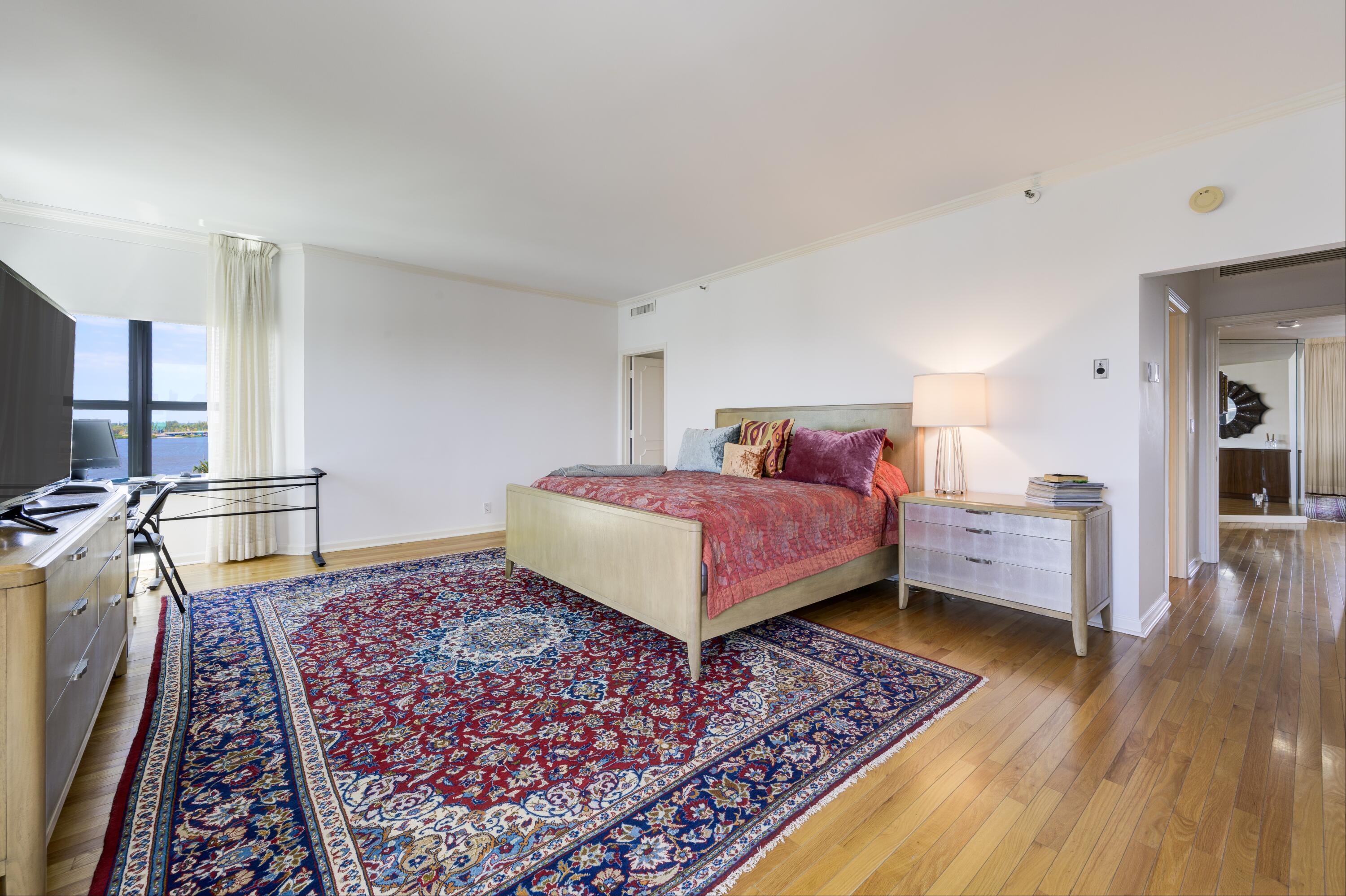 3120 South Ocean Boulevard, Unit 3602 Palm Beach, FL 33480 - Photo 8 of 22 a bedroom with a bed and wooden floor