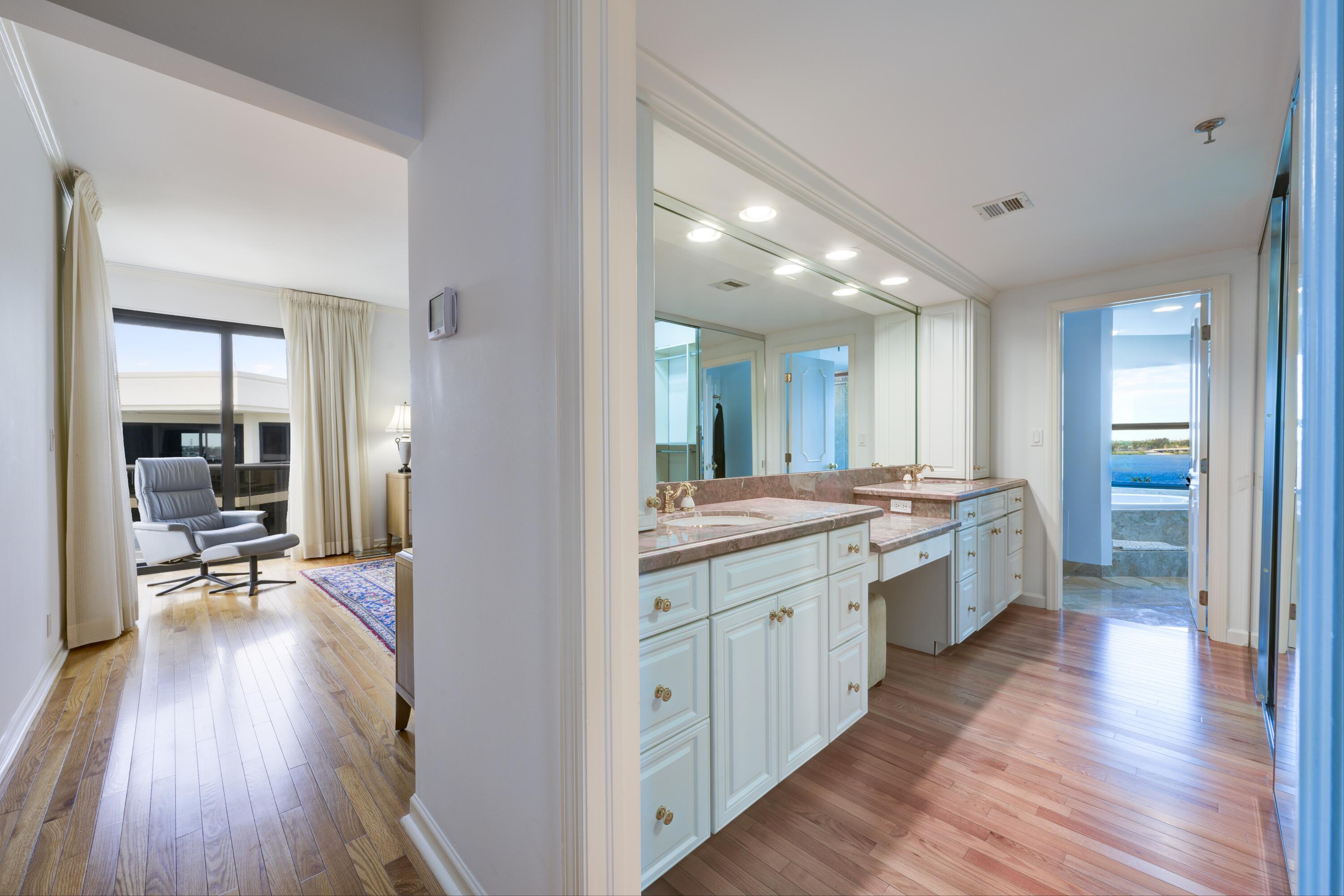 3120 South Ocean Boulevard, Unit 3602 Palm Beach, FL 33480 - Photo 10 of 22 a large bathroom with a large mirror vanity and sink