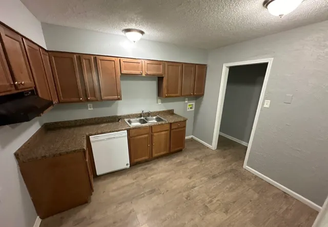 a kitchen with stainless steel appliances a stove a sink and a refrigerator