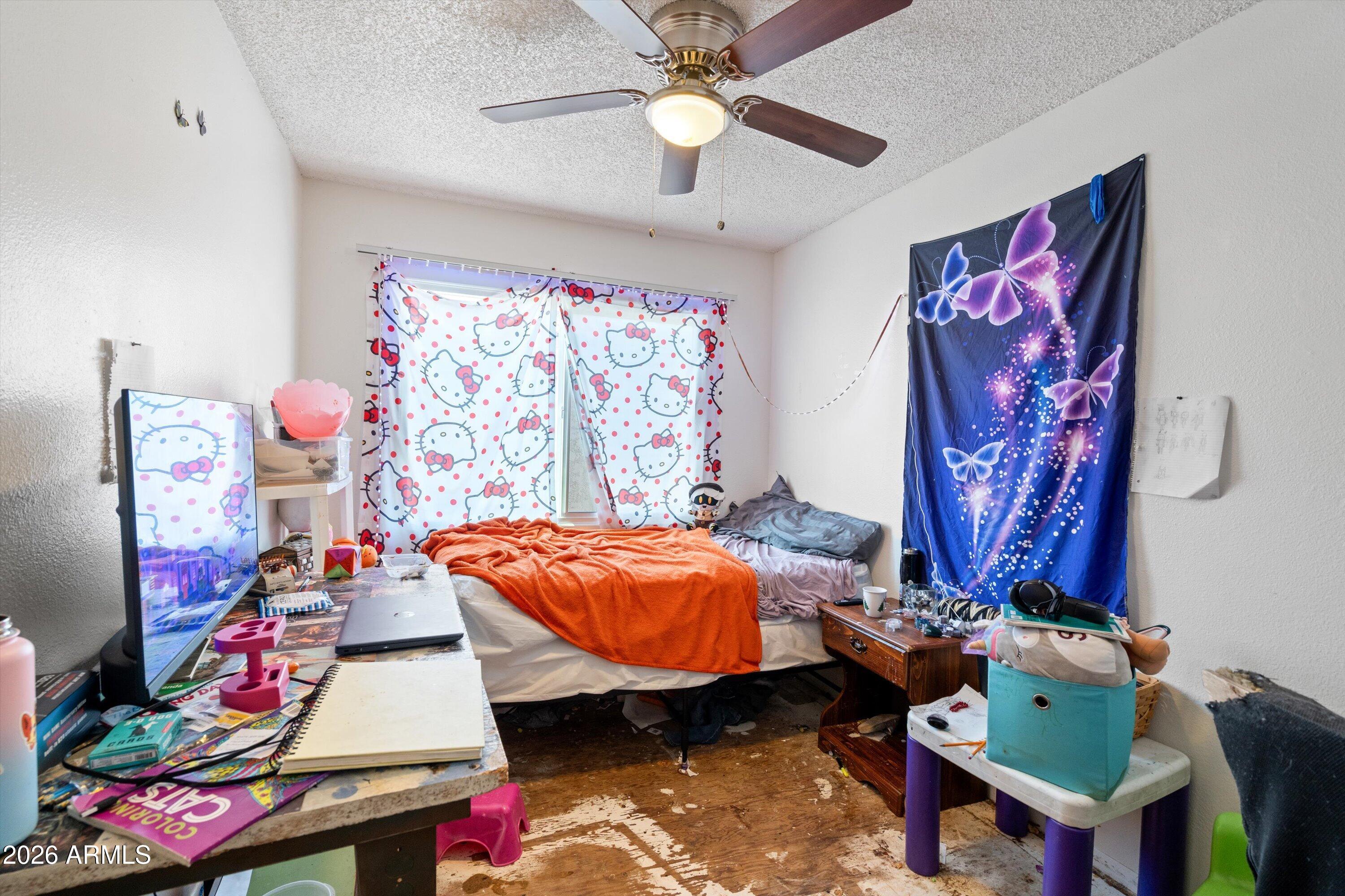 600 South Dobson Road, Unit 88 Mesa, AZ 85202 - Photo 17 of 18 a bedroom with a bed table and a chandelier