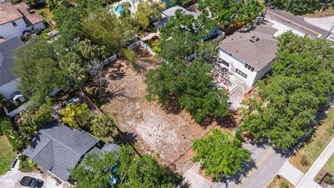 an aerial view of a house with a yard and garden