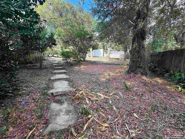a view of a house with a backyard