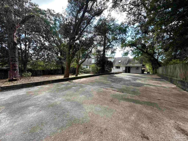 a backyard of a house with barbeque oven and outdoor seating