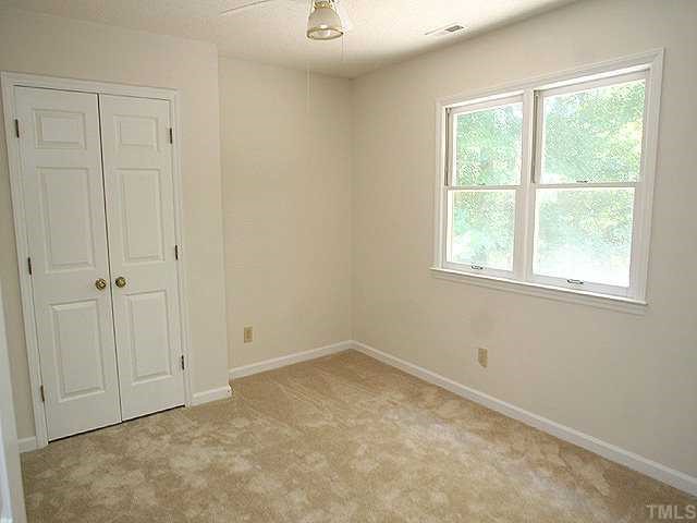 158 Lin Tilley Road Durham, NC 27712 - Photo 10 of 12 an empty room with a window