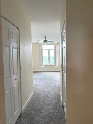 an empty room with windows and closet