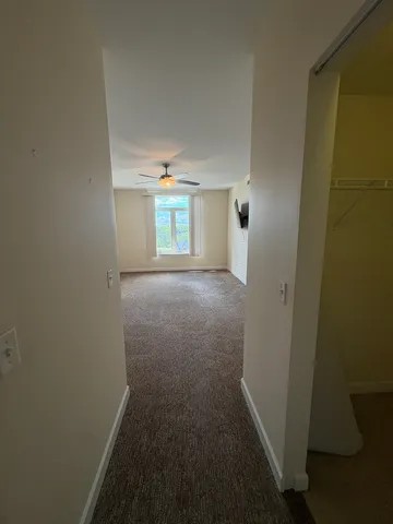 a view of hallway with wooden floor