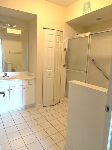 a bathroom with a shower and a sink