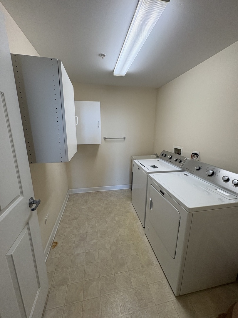 8300 Callie Avenue, Unit 610 Morton Grove, IL 60053 - Photo 25 of 32 a utility room with dryer and washer