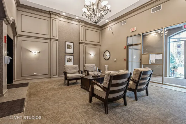 a living room with furniture and a chandelier
