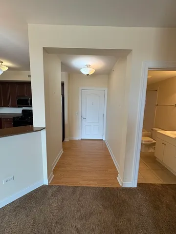 a view of a hallway to rooms