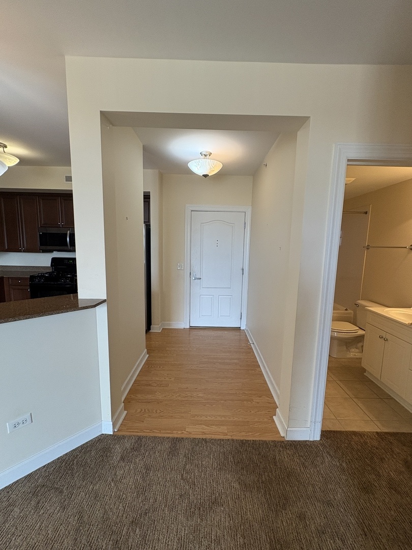 8300 Callie Avenue, Unit 610 Morton Grove, IL 60053 - Photo 4 of 32 a view of a hallway to rooms