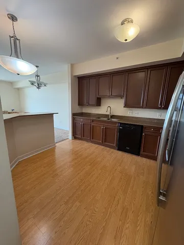 a kitchen with kitchen island a stove a sink and a refrigerator
