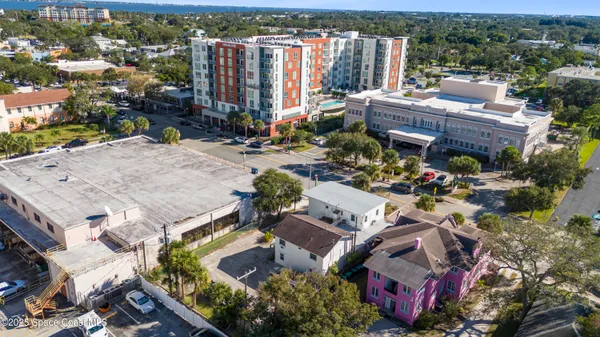 an aerial view of a house with a garden and lake view