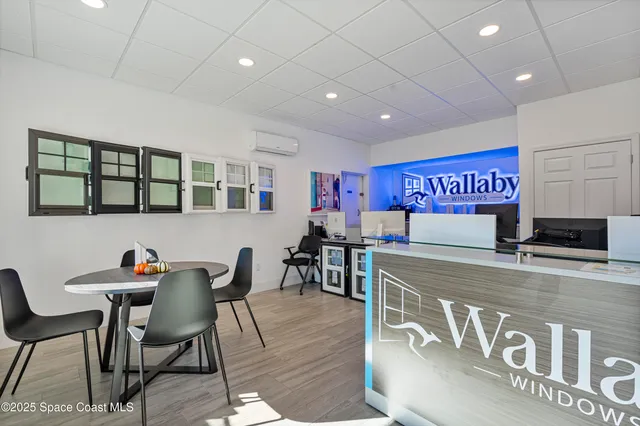 a view of a room with furniture and windows