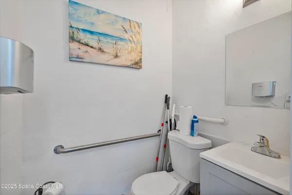 a white toilet sitting next to a bathroom sink
