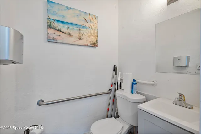 a white toilet sitting next to a bathroom sink