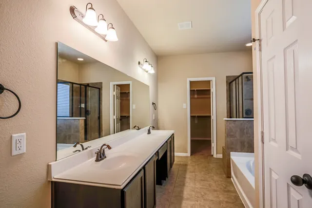 a en suite bathroom with a sink a toilet and shower