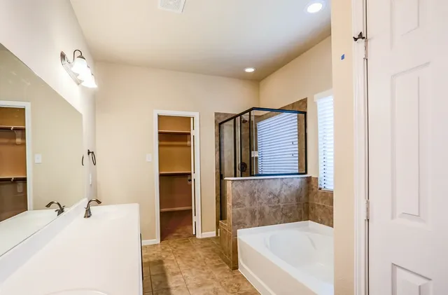 a bathroom with a tub and a sink