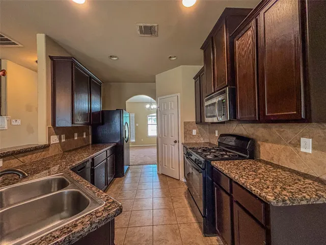 a kitchen that has a sink and a stove