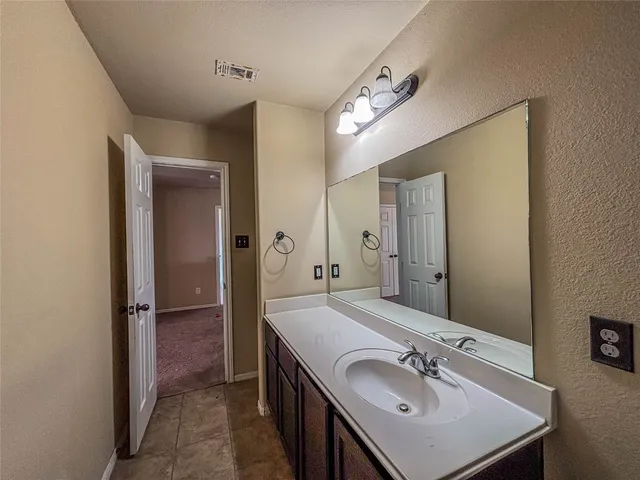 a bathroom with a sink double vanity and a mirror