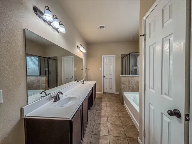 a bathroom with a double vanity sink and a mirror