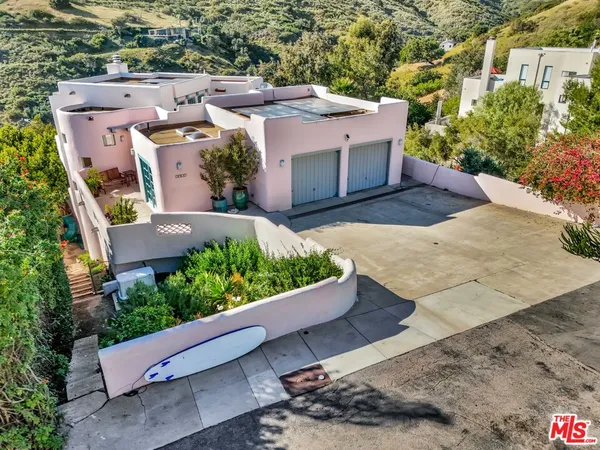 an aerial view of a house with a yard and plants