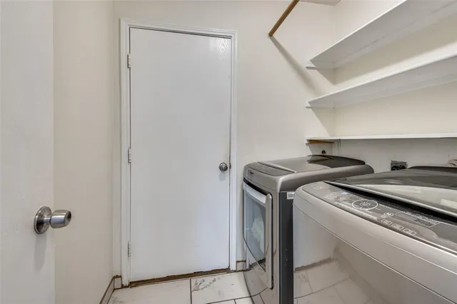 a kitchen with granite countertop wooden cabinets stainless steel appliances and a sink