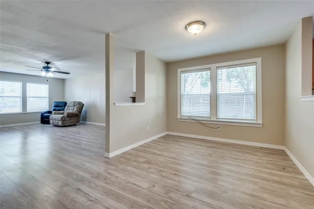a view of room with window and wooden floor