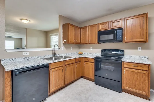 a kitchen with refrigerator and cabinets