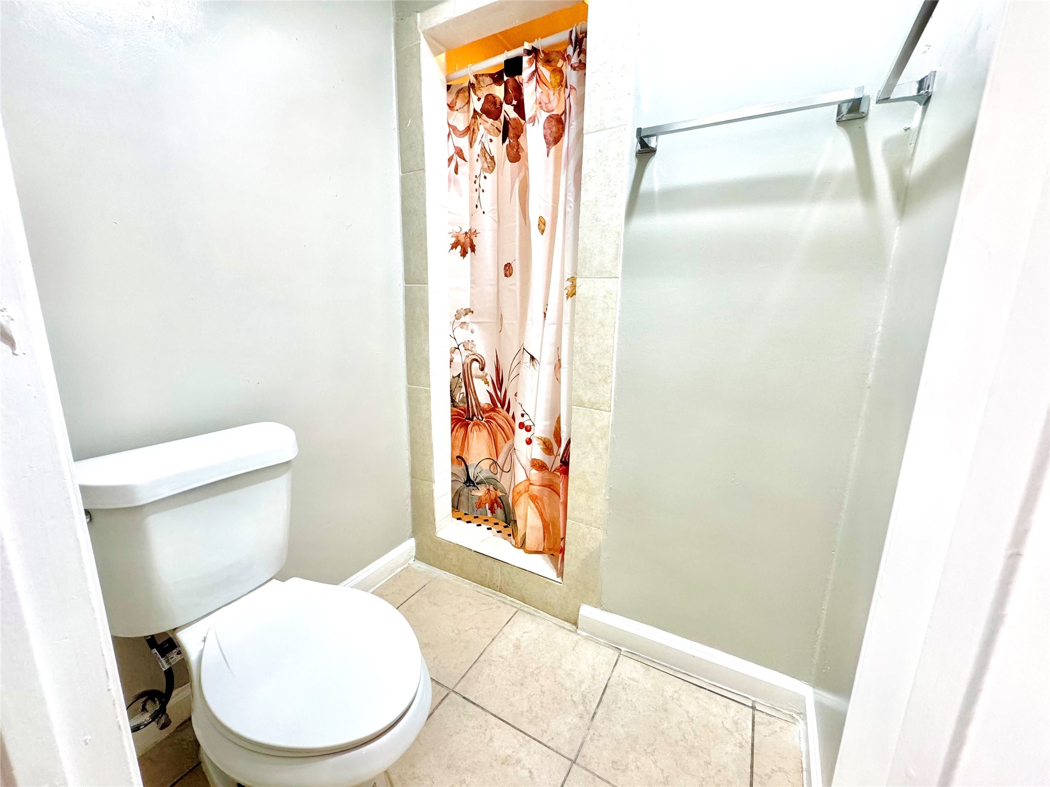 9090 South Braeswood Boulevard, Unit 47 Houston, TX 77074 - Photo 11 of 30 a white toilet sitting next to a shower curtain