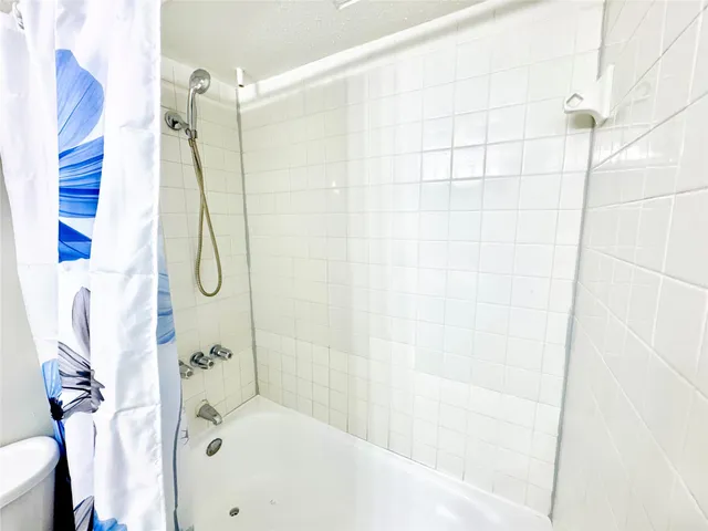 a bathroom with a shower and a shower