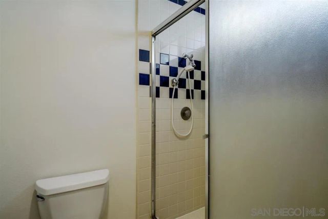 a bathroom with a shower and mirror