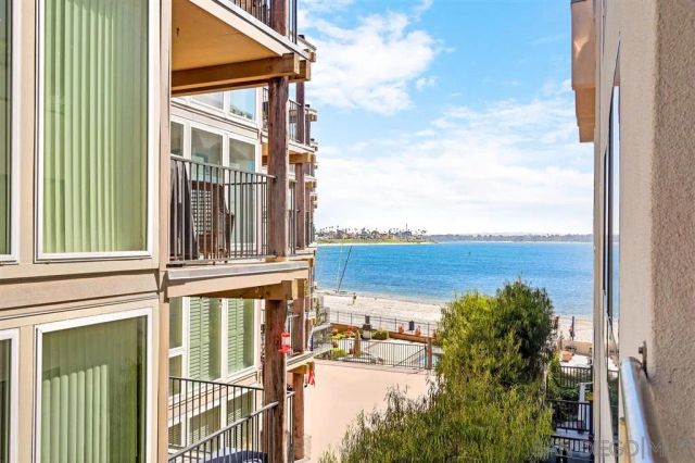 a view of a house with a windows and wooden fence