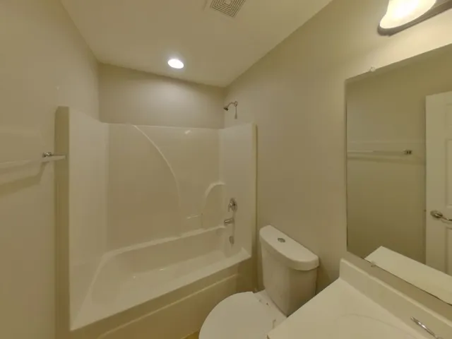 a bathroom with a toilet and shower