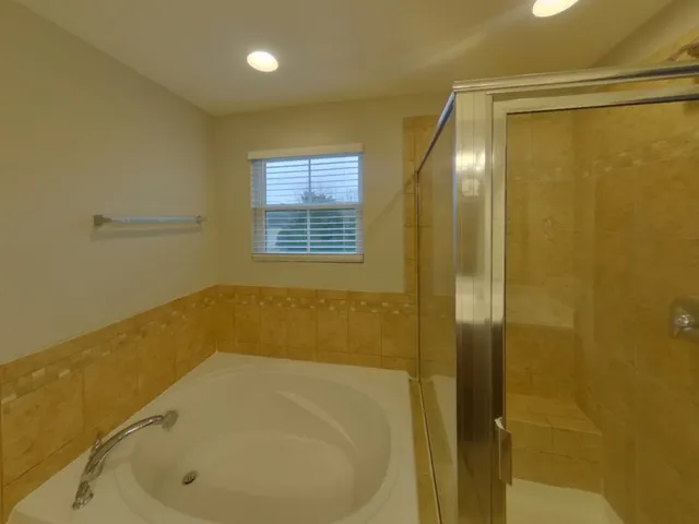 a bathroom with a tub and shower