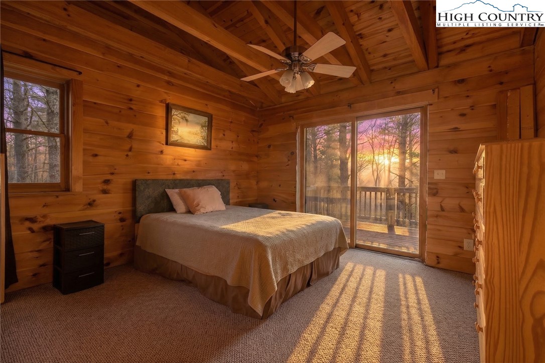 268 Roaring Ridge Road Deep Gap, NC 28618 - Photo 15 of 34 a spacious bedroom with a bed and wooden floor