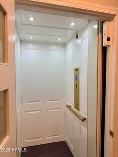 a room with a sink mirror and a lamp