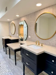 a bathroom with a sink a mirror and shower