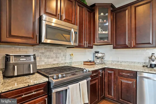 a large kitchen with a table and chairs
