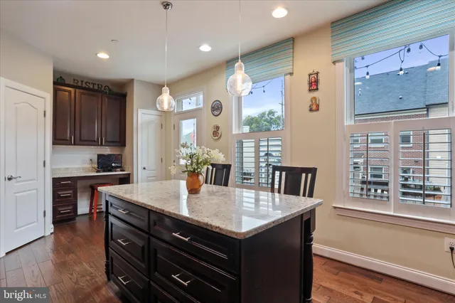 a kitchen with a sink and a wooden floor