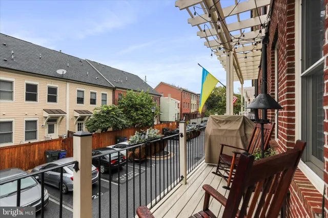 a view of kitchen with wooden floor and cabinets