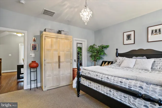 a bedroom with a bed and a chandelier