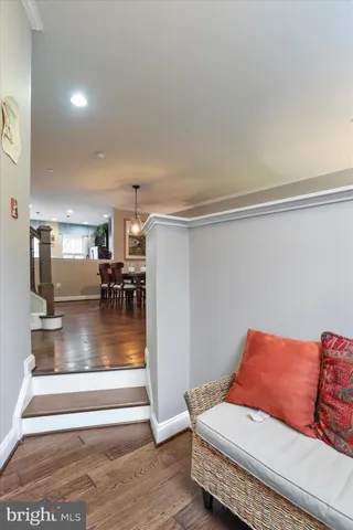 a living room with furniture and a dining table